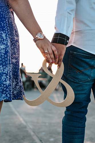 holding hands man and woman holding ampersand decoration flip-flop